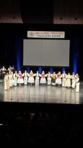 Klub Stepinac taking a bow on stage at the Canadian-Croatian Folklore Festival in Hamilton, under the Kanadsko Hrvatski Folklorni Savez banner.