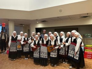 Klub Stepinac girls in Dalmatian folk costumes with their tamburice, posing backstage.
